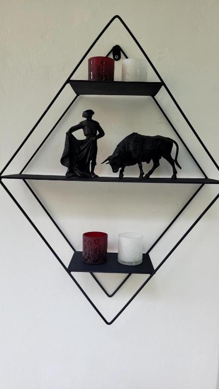 a shelf with a statue of a man and a bear at 3+1 Bağdat Caddesine yakın in Istanbul