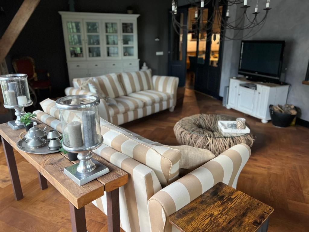 a living room with a couch and a table at Casa Fuori in Oirschot