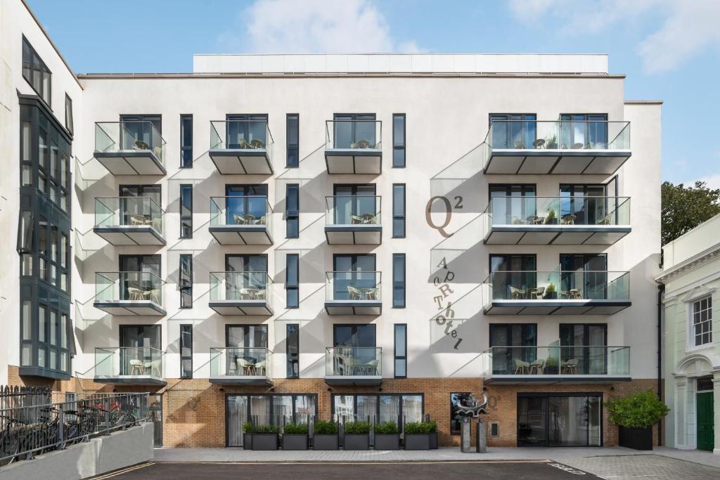 an apartment building with balconies on a street at Q Square by Supercity Aparthotels in Brighton & Hove