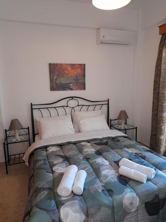 a bedroom with a bed with two pillows on it at Kate House in Agioi Apostoli