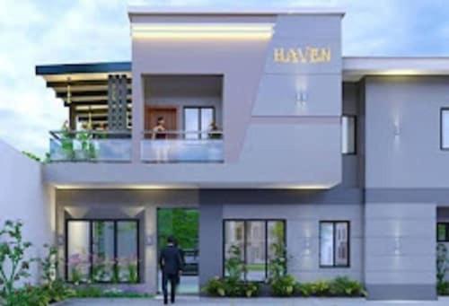 a man walking in front of a house at THE HAVEN SUITE in Lagos