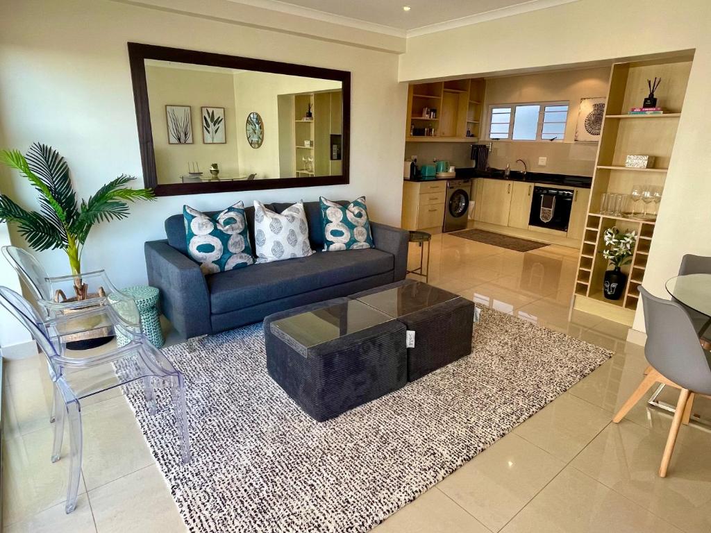 a living room with a couch and a coffee table at Ideal location, Mouille Point in Cape Town
