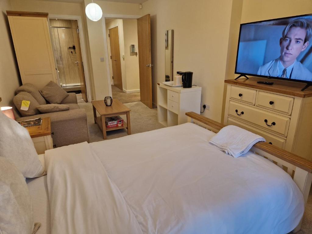 a bedroom with a bed and a flat screen tv at West Beck House in Darlington