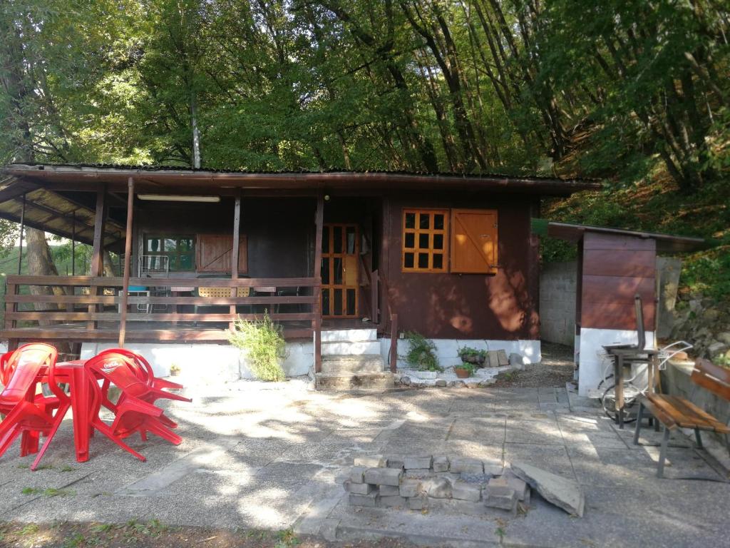 una casa con mesas rojas y sillas delante de ella en Casa d' Amore, 