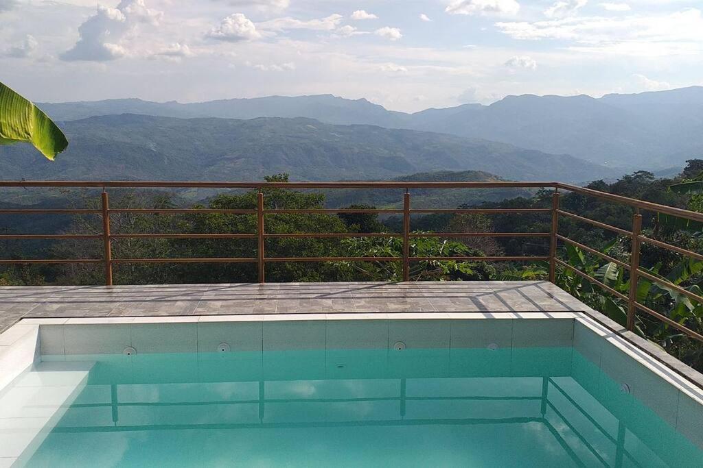 a swimming pool with a view of the mountains at Espectacular casa familiar in Lamas