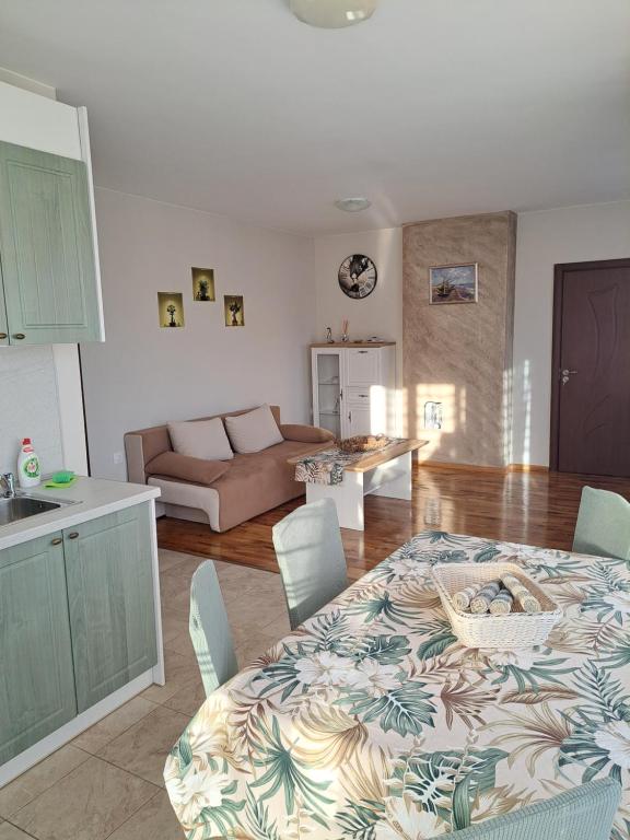 a kitchen and living room with a table and chairs at Megi Apartments, Nesebar sity in Nesebar
