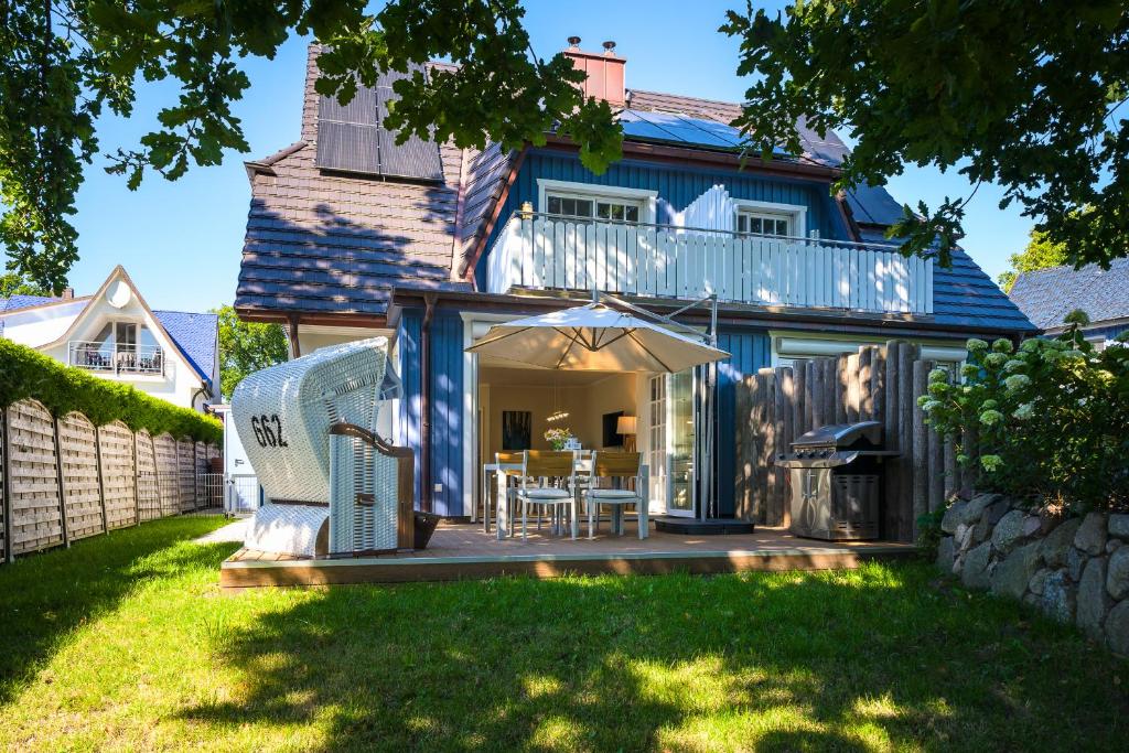 a house with a deck and a patio at Traumhaus Auri in Prerow/Ostsee auf dem Darß in Prerow