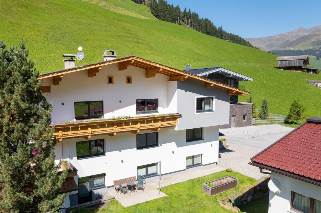 an external view of a building with a hill in the background at Ferienwohnung Tux in Tux