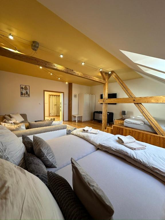 a room with a bunch of beds in it at Apartmán u Dómu in Olomouc