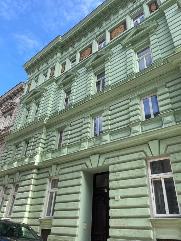 a green building with a door in front of it at Apartmán u Dómu in Olomouc