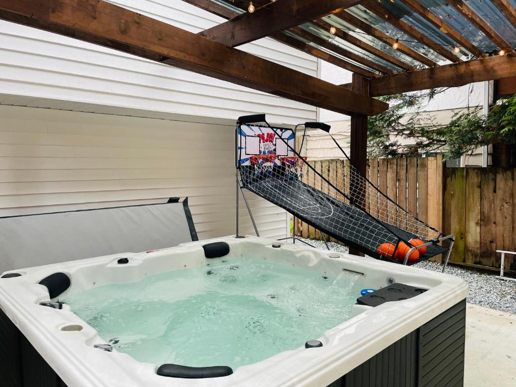 a hot tub on a patio with a ladder at Luxury Smart Home ~ Perfect Getaway Resort/Sleeps 14 in Langley