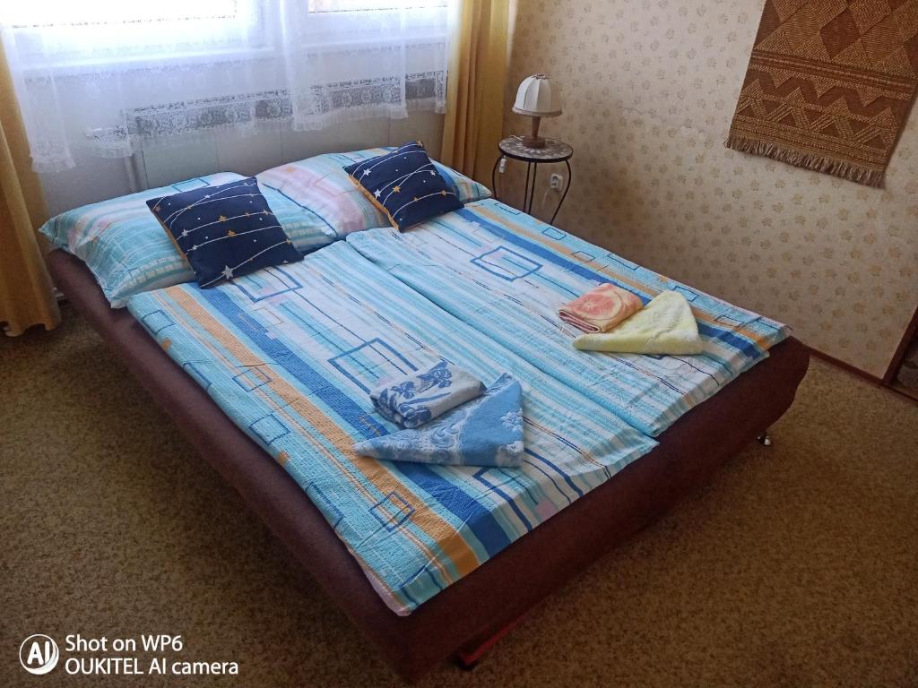a bed with clothes and towels on top of it at Rodinný dům pro hosty Vysočiny 
