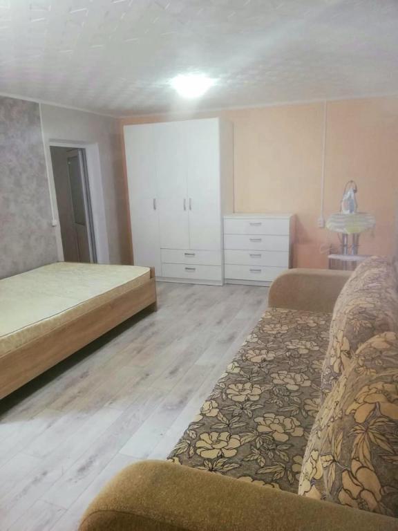 a large bedroom with two beds and a dresser at Дом in Oral