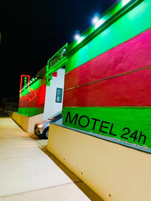 a colorful building with the words motel on it at Motel Jaguar Contagem in Contagem