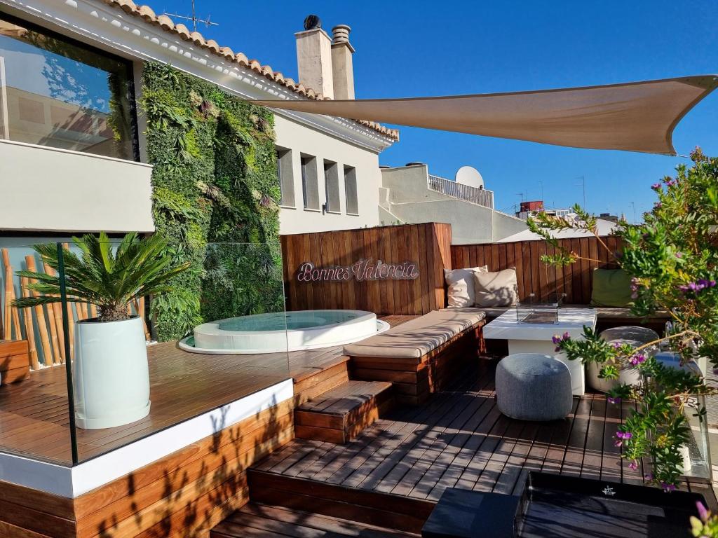 an outdoor patio with a couch and a table at BONNIES Suites & Spa Valencia in Valencia