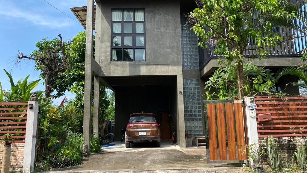 a car is parked inside of a garage at Modern Loft Style in Nakhon Phanom