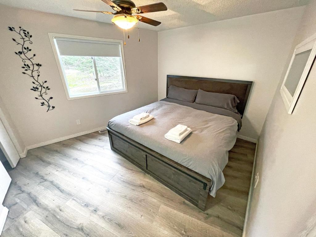 a bedroom with a bed with two towels on it at Forest Retreat - Pool - Games - Fireside Joy in Cayuga