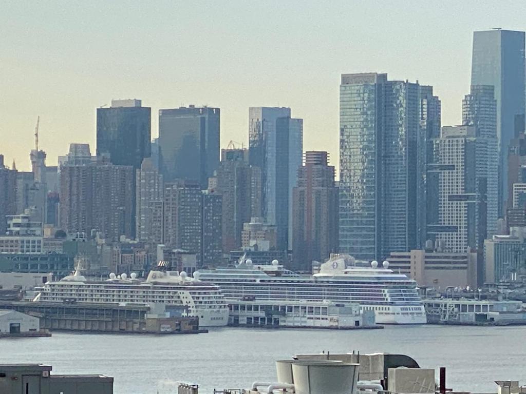 a city skyline with cruise ships in the water at Room with Jacuzzi, Massage Seat, and Parking Spac, THE BEST CHOICES!! in North Bergen