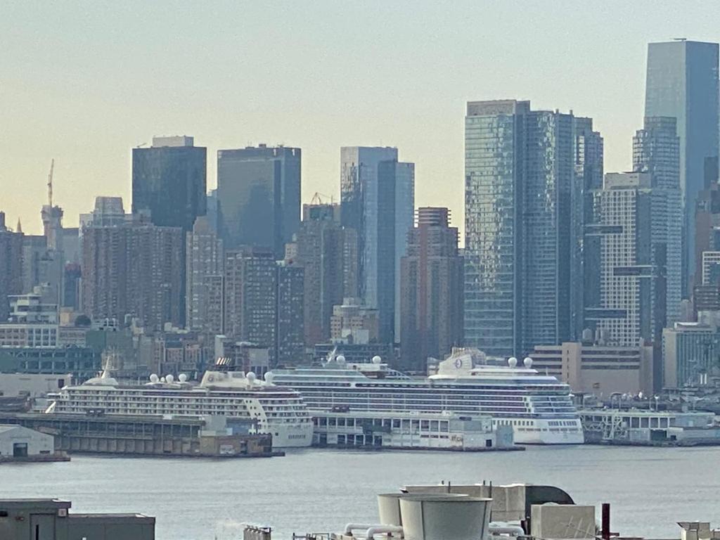 a city skyline with cruise ships in the water at Nice 2 bedrooms, Massage Seat, close to New York, THE BEST CHOICE!! in North Bergen