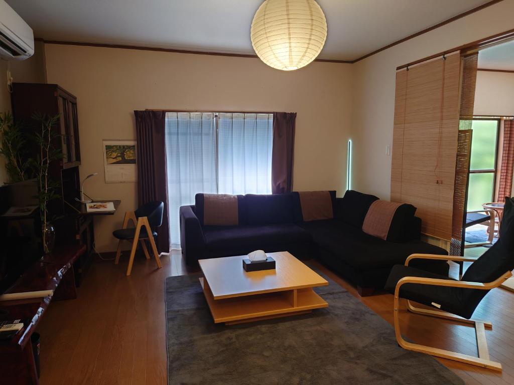 a living room with a couch and a coffee table at 竹の宿 in Nagao