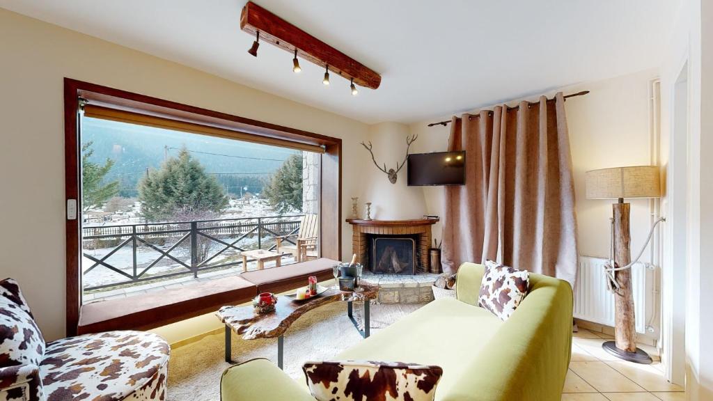 a living room with a couch and a fireplace at Parnassos Chalets in Arachova