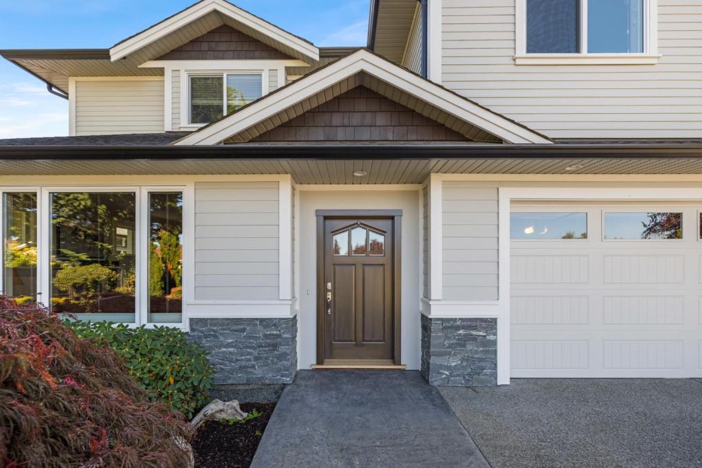 a house with a brown door and a garage at Private House Rental! Classic, Elegant, Comforting in Sidney