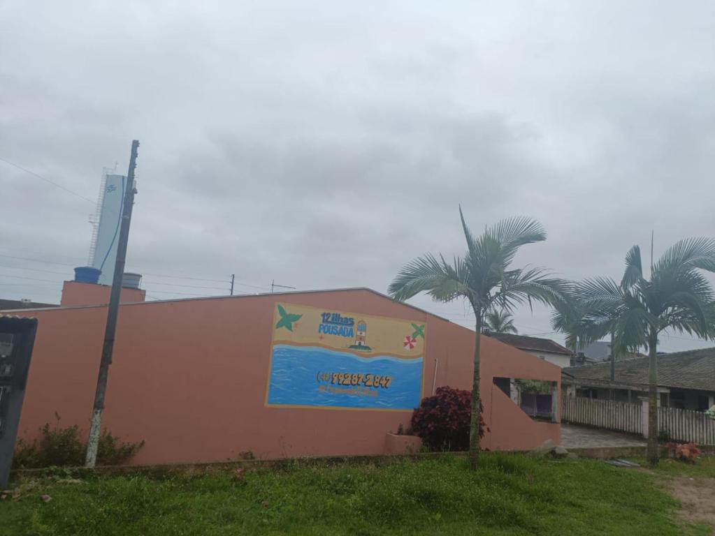 a building with a sign on the side of it at Pousada 12 Ilhas in Pontal do Paraná