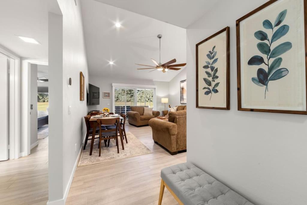 a living room and dining room with a dining table at Luxurious fairway condo resort country club in Palm Desert