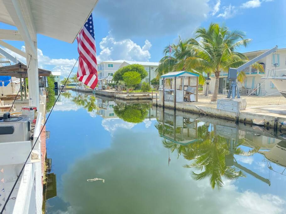 an american flag on a boat in a canal at key Deer Retreat/direct gulf access/hot tub in Big Pine Key