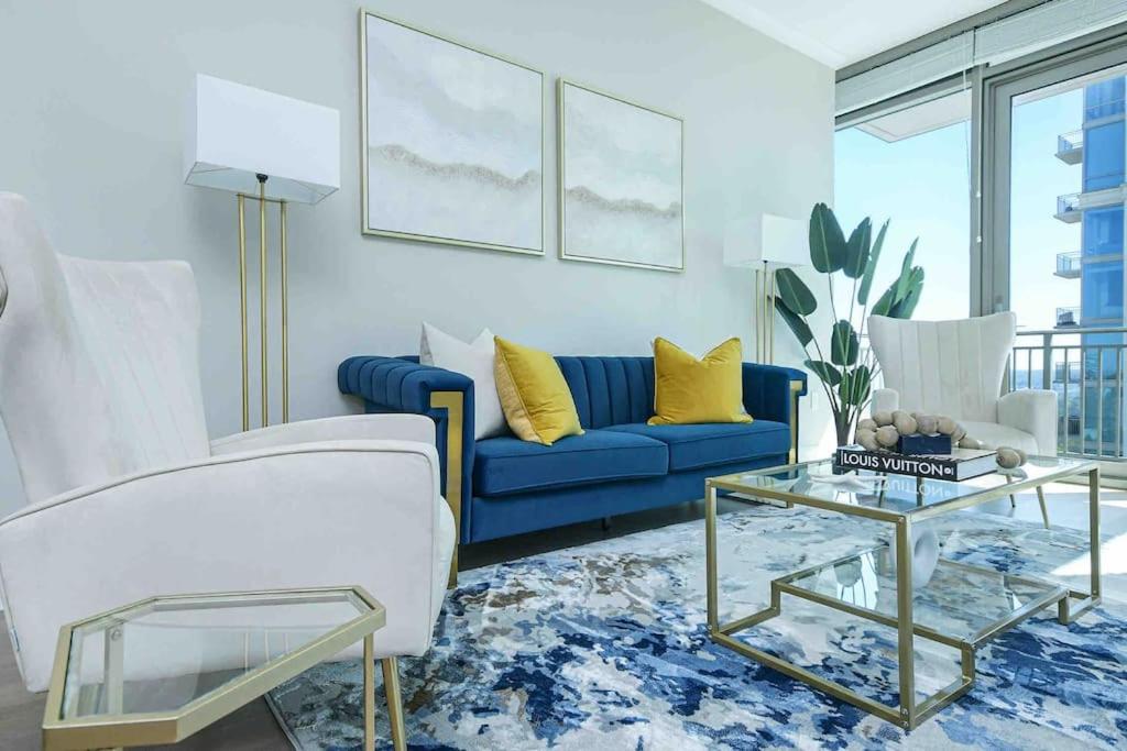 a living room with a blue couch and a table at The Bleu Oasis in Atlanta