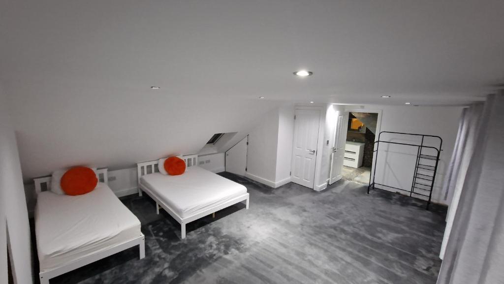 a white room with two beds and a ladder at Comfort Sleep in Windsor