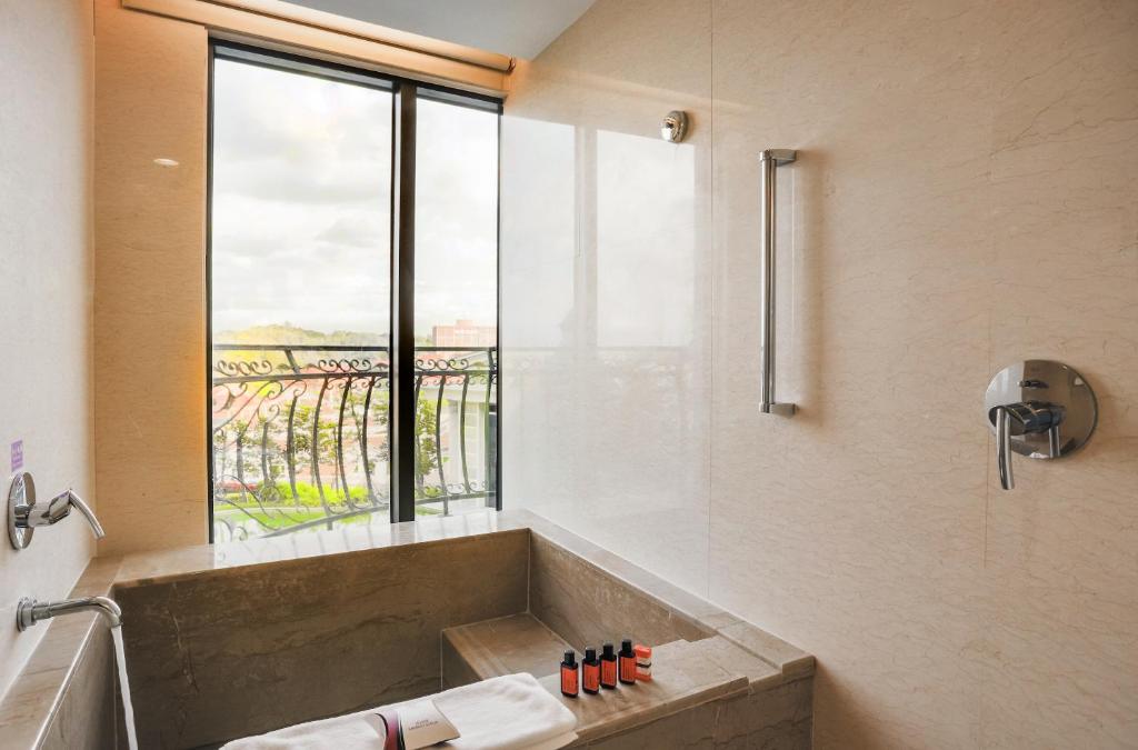 a bathroom with a tub with a large window at E-DA Royal Hotel in Dashu