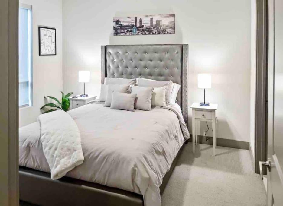 a bedroom with a large bed with white sheets and pillows at Modern Midtown Oasis in Atlanta