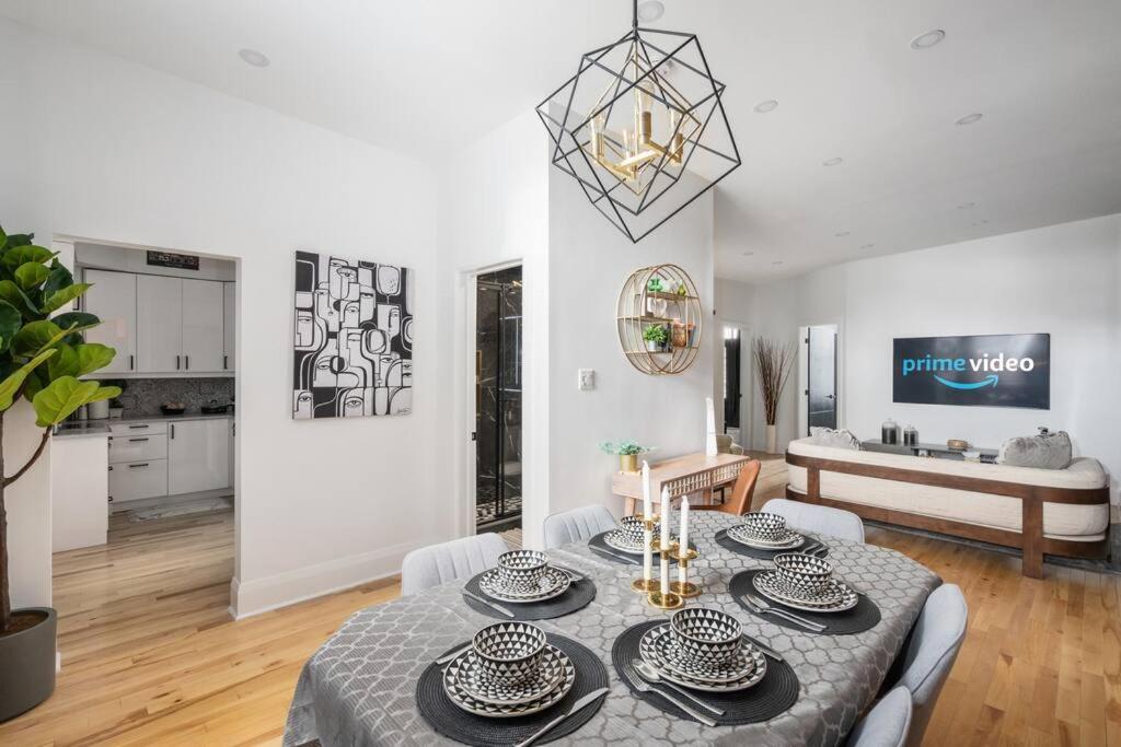 a living room with a table and a kitchen at Downtown Luxe: Metro, King Bed, Parking, Sleeps 6 in Montréal