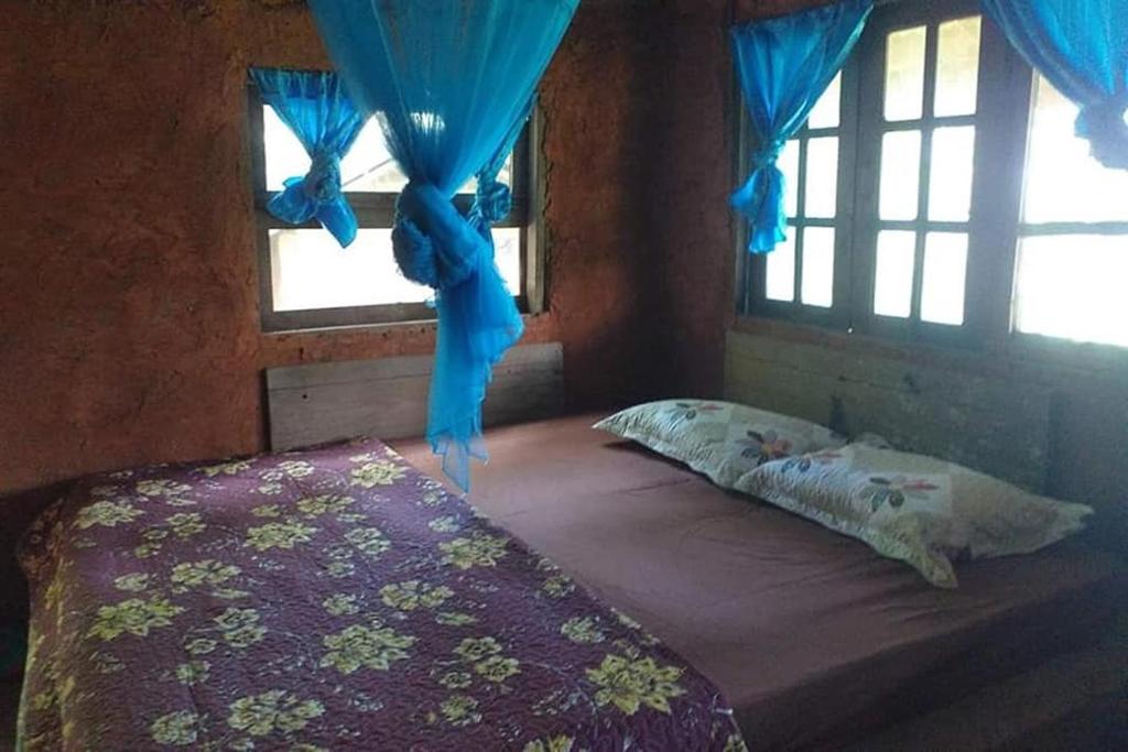 Postel nebo postele na pokoji v ubytování Doi PuMuen LAHU Homestay