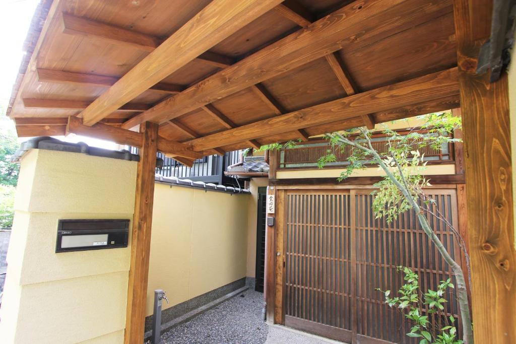 a pergola over a gate of a house at Our-Turn Traditional Machiya near Heian Shrine in Kyoto