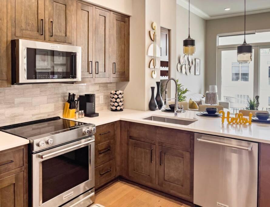 a kitchen with wooden cabinets and stainless steel appliances at Serenity In The City in Atlanta
