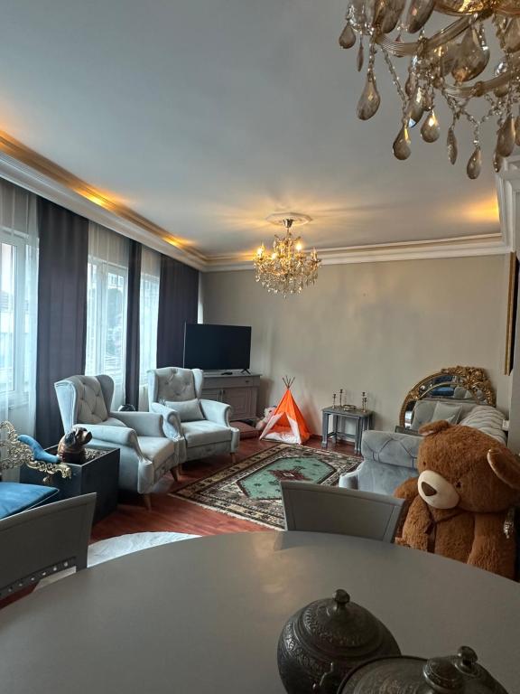 a living room with a teddy bear in the middle of the room at In the city center, near metro, Şişli, Nişantaşı in Istanbul