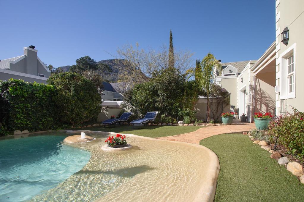 a swimming pool in the middle of a yard at Sunflower Villa in Franschhoek in Franschhoek