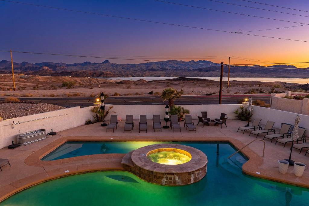 a swimming pool with a fire pit on a patio at LakeView Home Minute From New Launch With Pool And Spa in Lake Havasu City