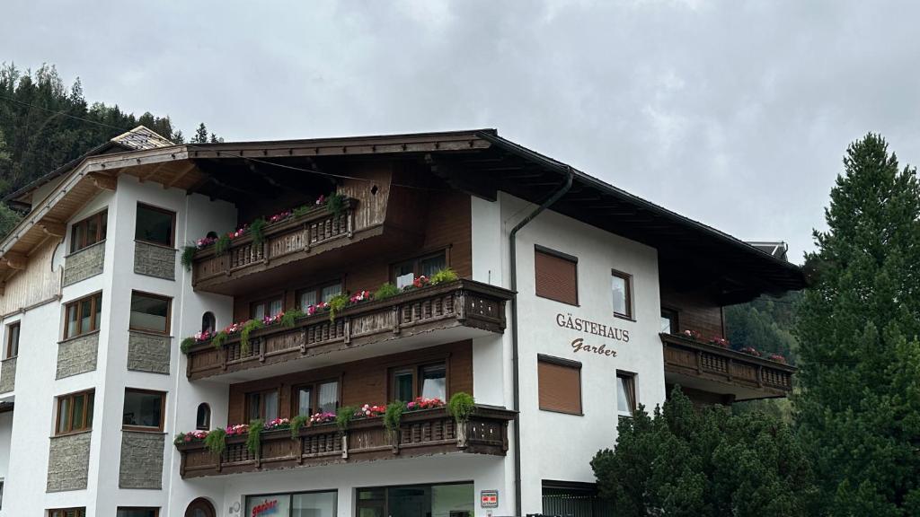 a building with flower boxes on the balconies of it at Gästehaus Garber in Stumm