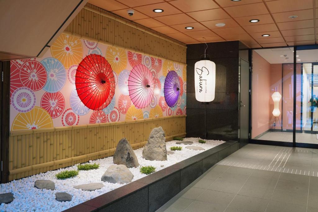 a lobby with colorful umbrellas on the wall at Park Central Sakura Hotel in Osaka