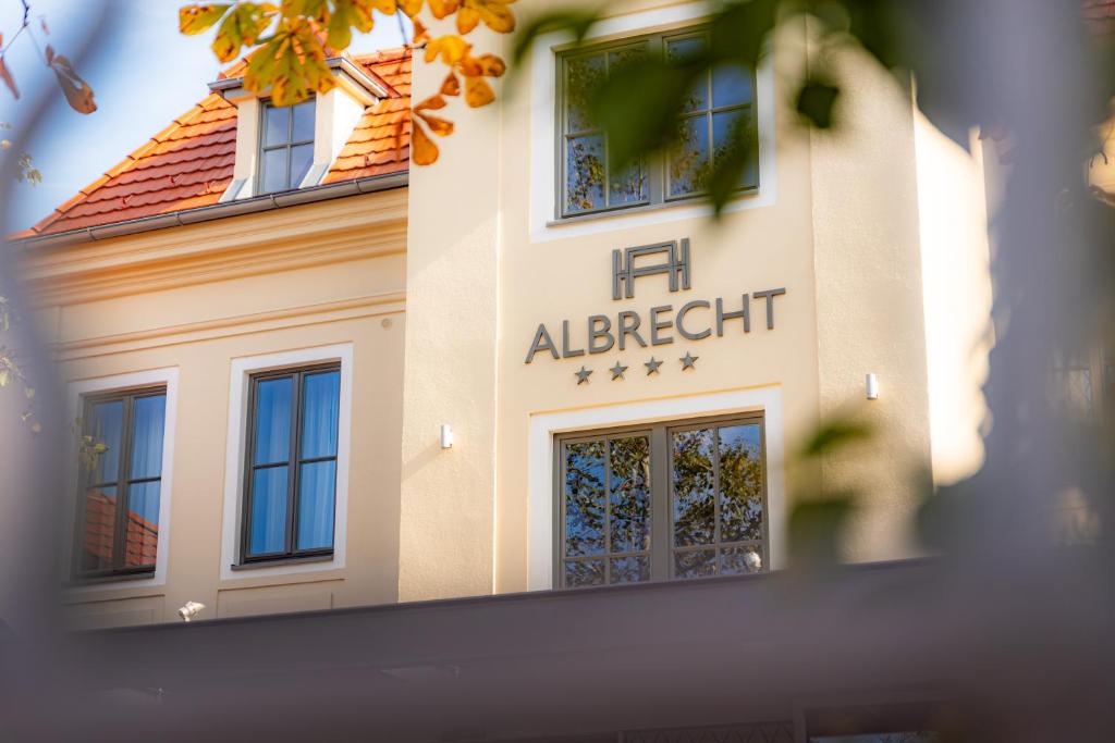 un edificio con el letrero de albert a un lado en Hotel ALBRECHT en Bratislava