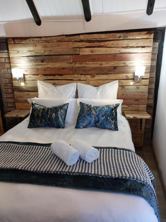 a bedroom with a bed with two pillows at The Spare Room Cottage - cosy and private in Bloemfontein