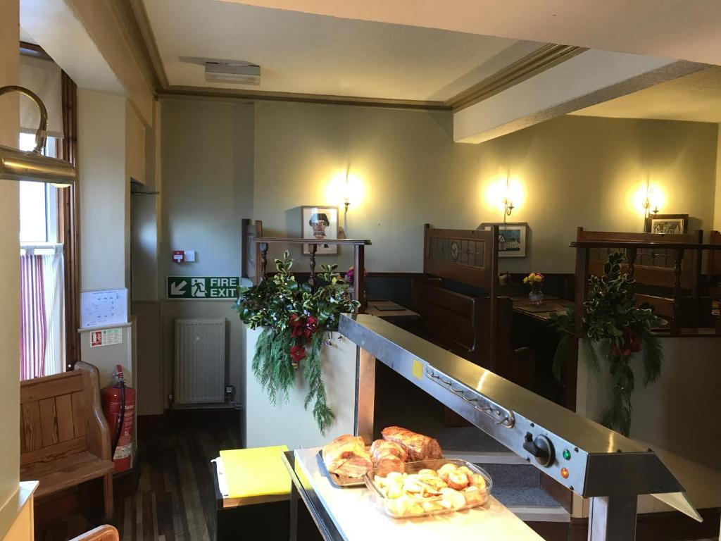 a room with a table with some pastries on it at The Victoria Hotel in Pwllheli