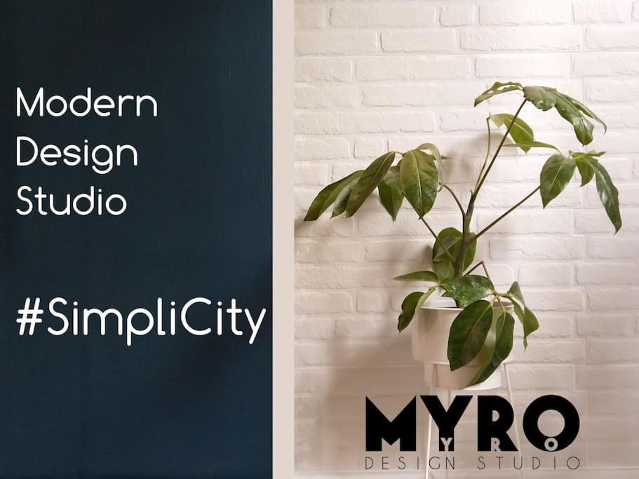 een plant in een pot zittend op een muur bij #SimpliCity Modern Design Studio in Mytilini