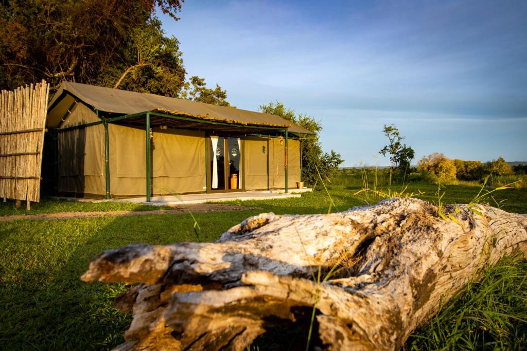 a large tree log in front of a tent at Sian-simba-river-lodge in Victoria Falls