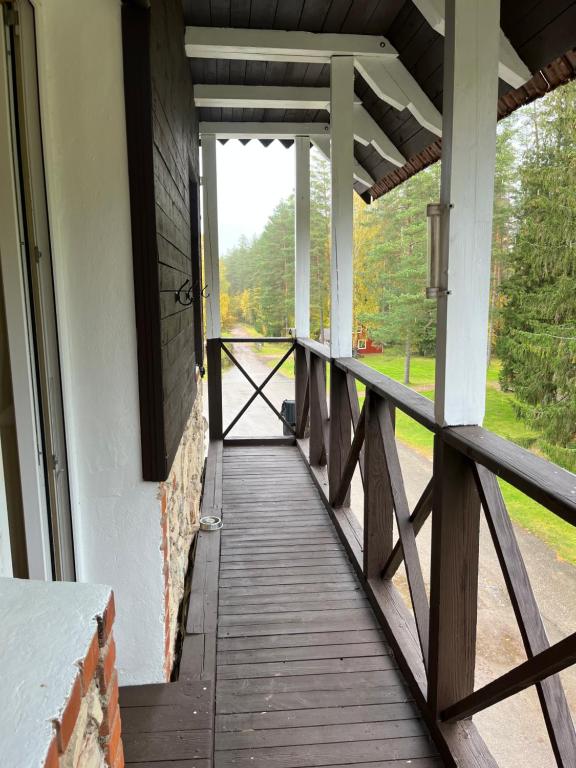 a porch of a building with a wooden walkway at Baiļi in Valmiera