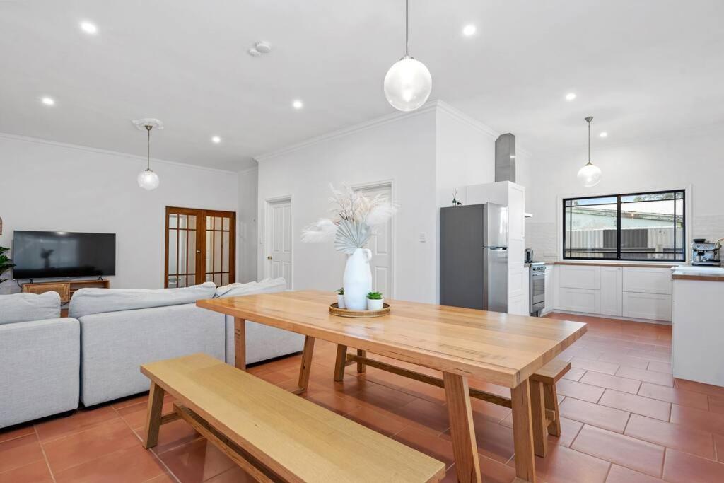 a living room with a table and a couch at Super House, Super Host in Kalgoorlie