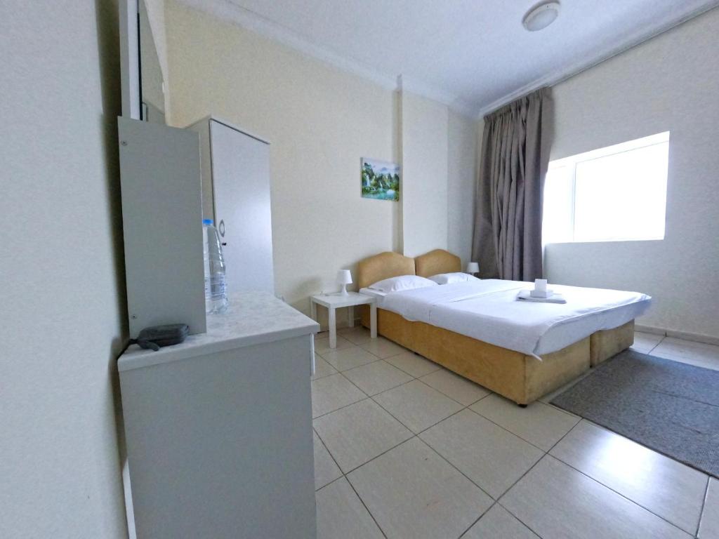Postel nebo postele na pokoji v ubytování Abu Hail Star Residence - Home Stay